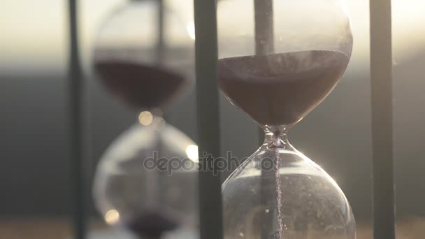 Time concept. Silhouette of Hourglass clock and smoke on blurred .