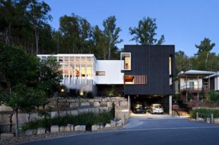 Black and White Timber Clad 3 Storey House on The Hill Side .
