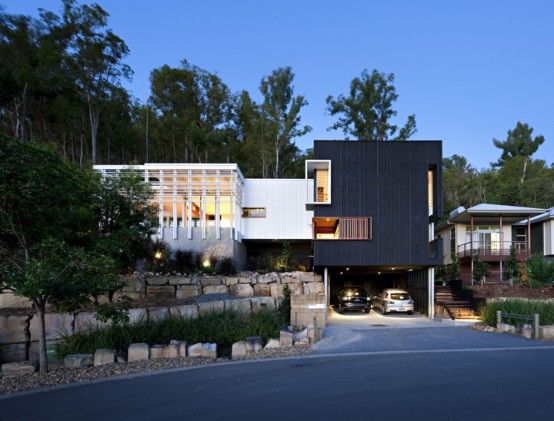 Black and White Timber Clad 3 Storey House on The Hill Side .
