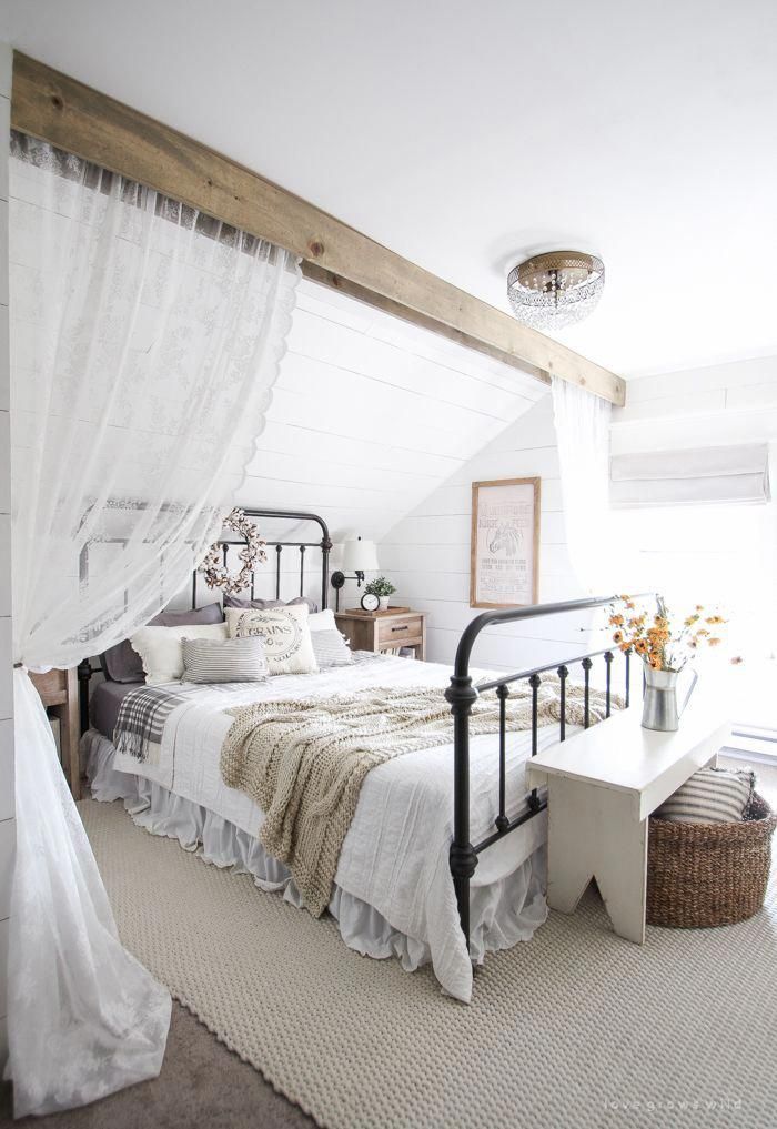 A beautiful farmhouse bedroom decorated with simple touches of .
