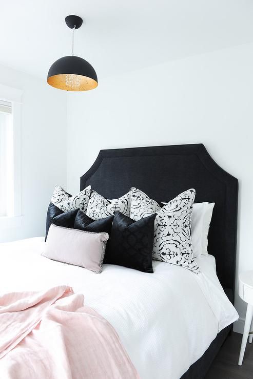 Chic black and white bedroom with pink accents boasts a striking .