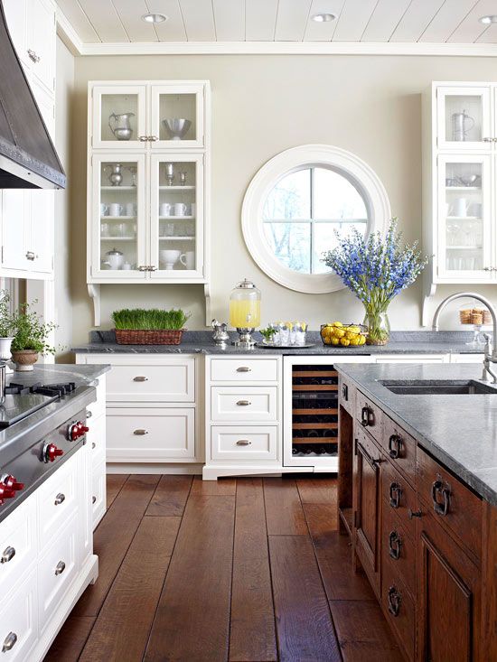 a chic rustic kitchen with white and stained furniture, a porthole .
