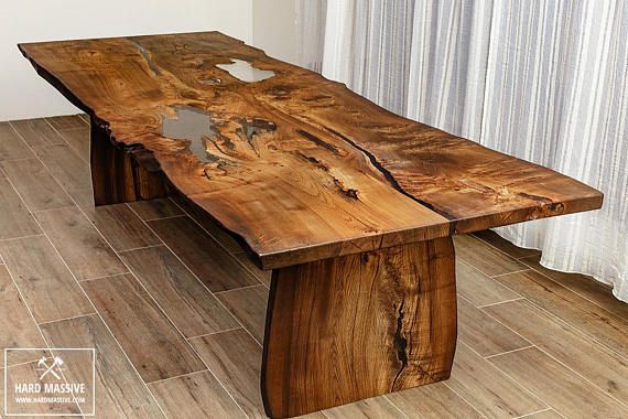 Modern wooden dining table made of solid wood Ash with a live edge .