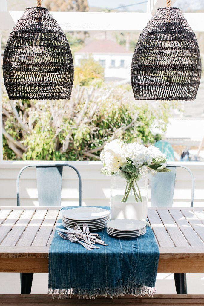 outdoor dining table details + black woven pendant lighting + blue .