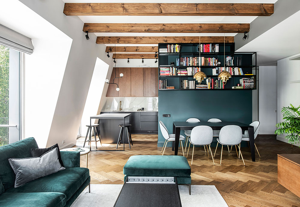 Minimalist attic apartment with beams for young couple in Vilnius .