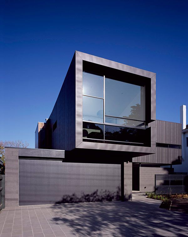 Contemporary house in minimalist style with dark exterior .