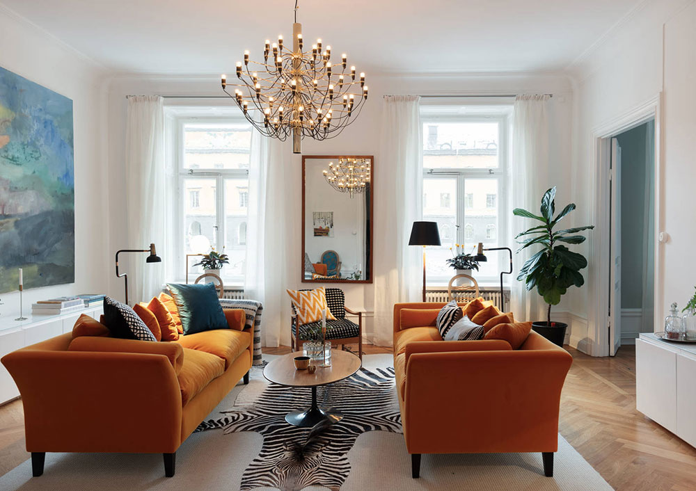 Orange sofa and huge paintings: beautiful Scandinavian apartment .