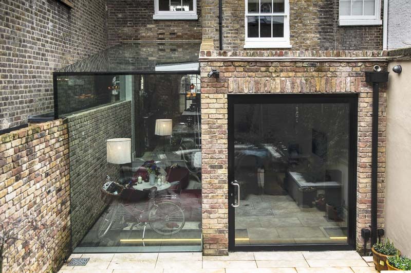Pivot door and frameless glass box extension modern houses by .