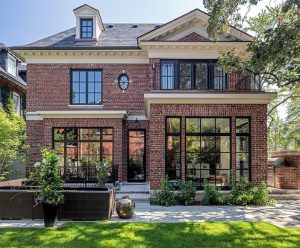 Classic transitional modern brick home with outdoor entertaining .