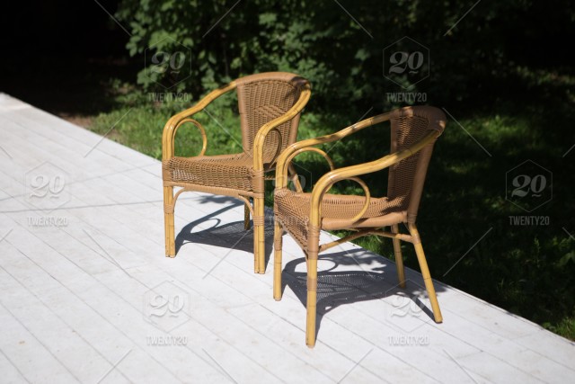 Two wicker chairs on the summer terrace. background, design .