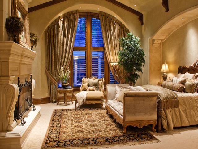 beautiful bedroom - great arched window and archway above the bed .