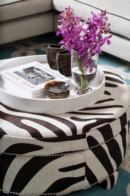 This ottoman is so chic with the zebra print and the metal studs .