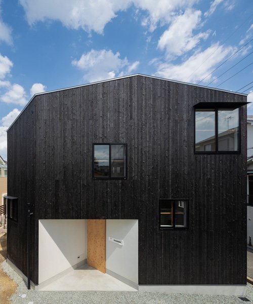 tato architects wraps house in takatsuki, japan, in charred wood .